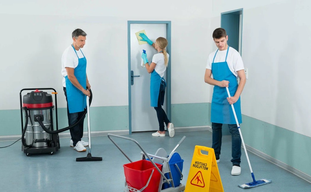 Residential Cleaning Services team mopping floors, vacuuming, and wiping surfaces in a clean indoor space.