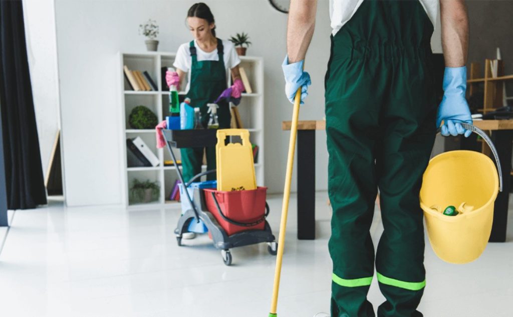 Professional team providing Airbnb Cleaning Services with mops, buckets, and cleaning supplies in a modern rental property.