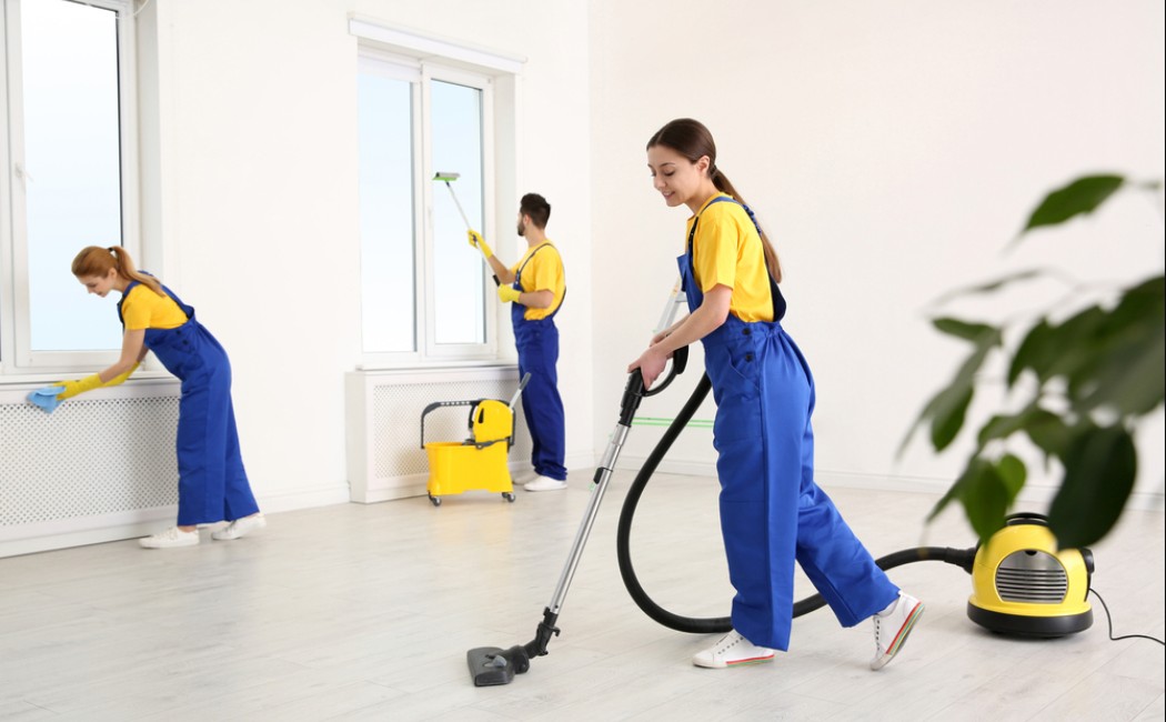 Move-Out Cleaning team vacuuming floors, wiping surfaces, and cleaning windows in an empty apartment to prepare it for the next occupant.