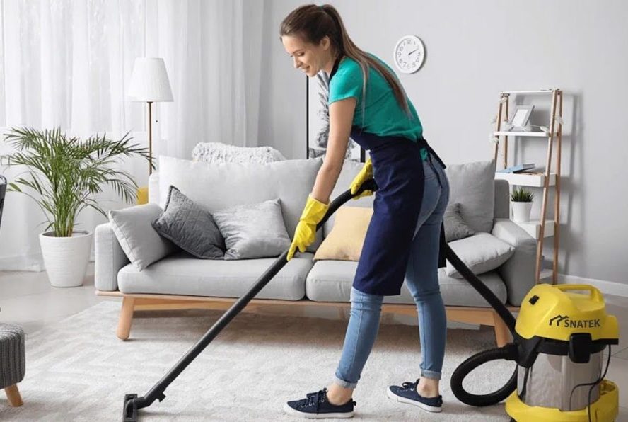 Apartment Cleaning professional vacuuming a living room for a fresh, spotless, and inviting home.