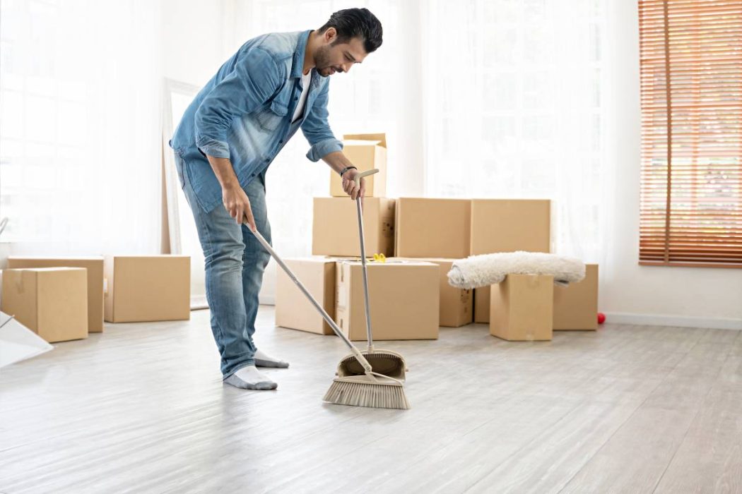 Professional Move-Out Cleaning Before Moving Day Move-Out Cleaning service with a homeowner sweeping floors after packing, ensuring a spotless home ready for the next occupants.