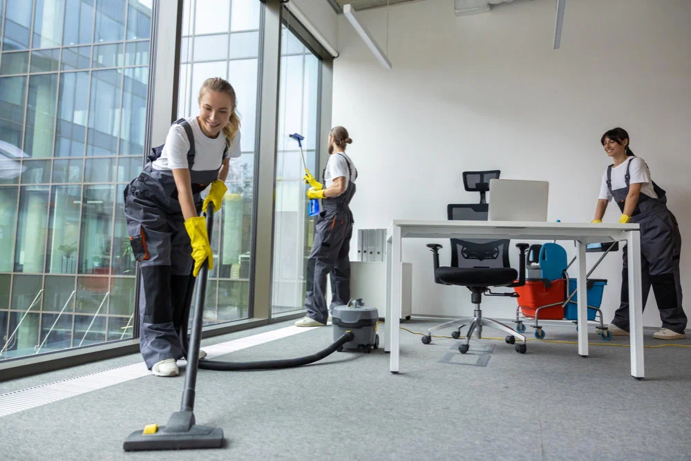 Commercial Cleaning professionals vacuuming carpets and keeping a modern office space fresh and tidy.