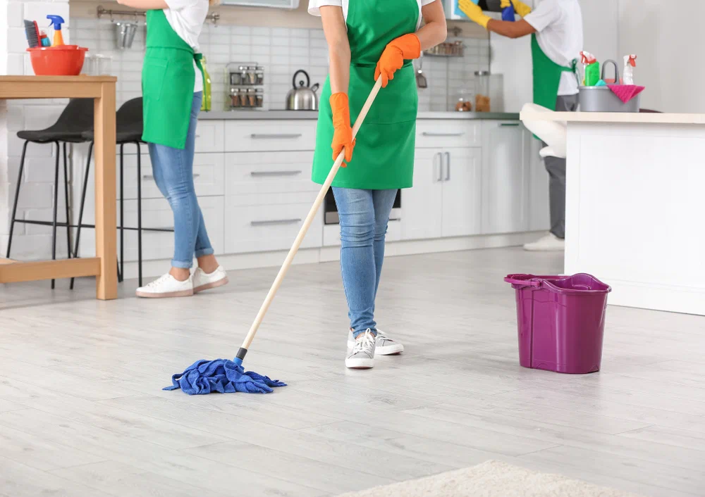 Cleaning Services team is mopping kitchen floors and maintaining a fresh, spotless home environment. 