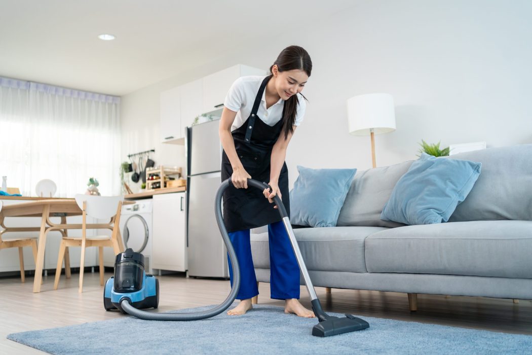 House Cleaning featuring a cleaner vacuuming a bright living room for a fresh, spotless home.